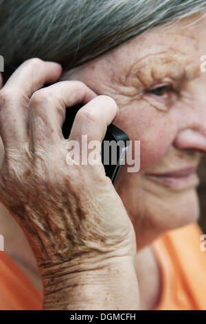 Elderly woman using a smartphone Stock Photo