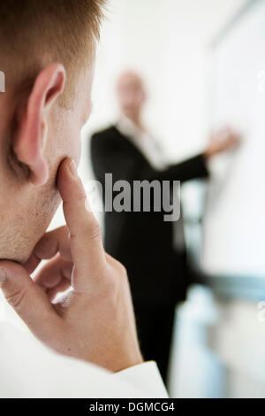 Speaker explaining something on a flip for his audience during a training Stock Photo