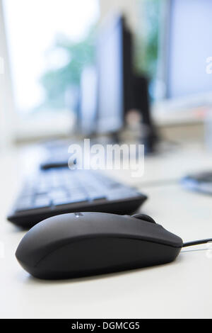 Computer monitors, keyboards and mouse in a training classroom Stock Photo
