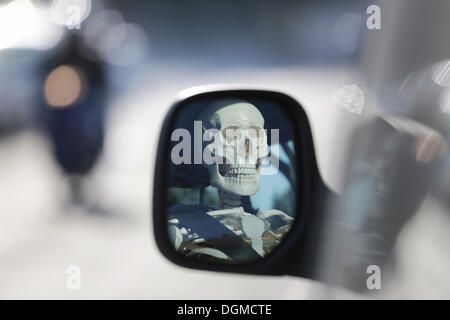Skeleton at the wheel of a car, skull reflected in the wing mirror of a car, Germany Stock Photo