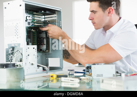 Handsome serious computer engineer working at open computer Stock Photo