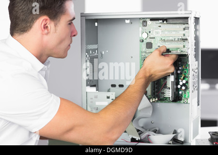 Handsome computer engineer working at open computer Stock Photo
