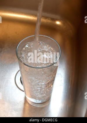 Filling a glass with water Stock Photo