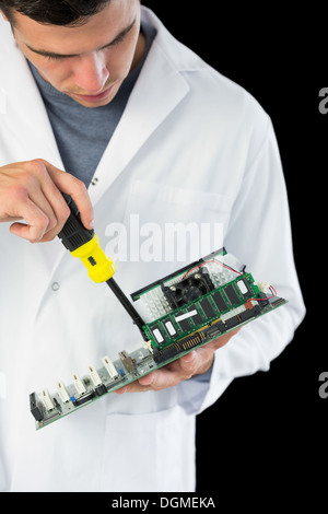 Attractive serious computer engineer repairing hardware Stock Photo