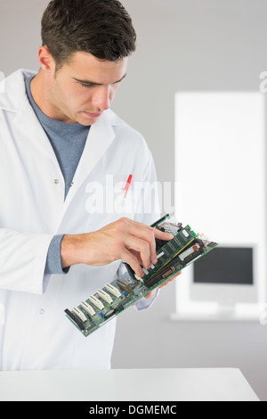 Attractive computer engineer holding hardware Stock Photo