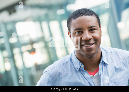 Summer in the city. Business people in casual clothes. A handsome man in a blue shirt. Stock Photo