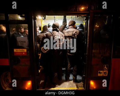 Riot police riding in public service vehicle of the Stuttgarter Strassenbahnen to a demonstration against Stuttgart 21 in Stock Photo