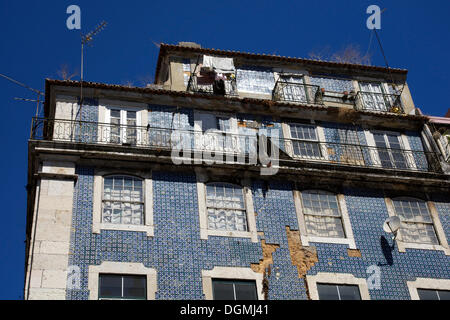 Crumbling tiles on the facade of a building in the old city of Lisbon, Portugal, Europe Stock Photo