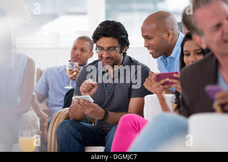 office event. A woman checking her smart phone. Stock Photo