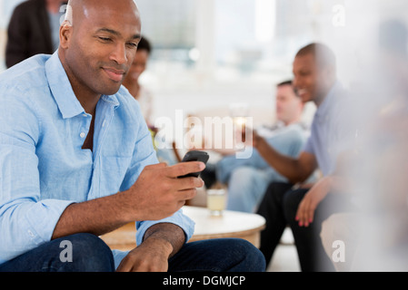 Office event. A man using his smart phone. Stock Photo