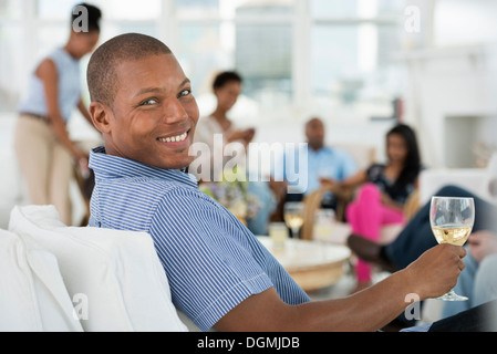 Office. A young man with a glass of wine. Stock Photo