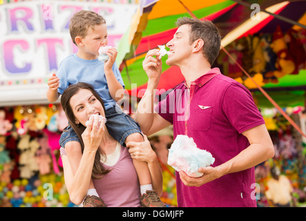 USA, Utah, Salt Lake City, Happy family with son (4-5) in amusement park eating cotton candy Stock Photo