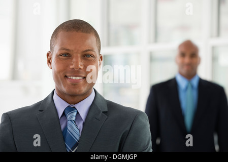 Two business men in suits one trying to choke the other Stock Photo - Alamy