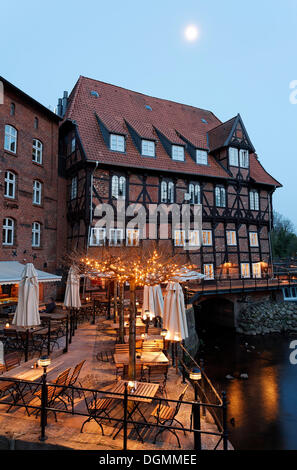 Restaurant terrace on the Ilmenau river, Bergstroem four-star hotel, evening mood, old town, Lueneburg, Lower Saxony Stock Photo