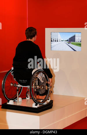 Child sitting in a wheelchair in front of a screen, disability simulation, Ideenpark 2012, technology and education summit Stock Photo