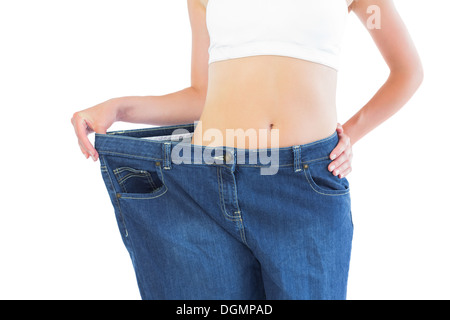 Close up of confident slender blonde wearing too big trousers Stock Photo