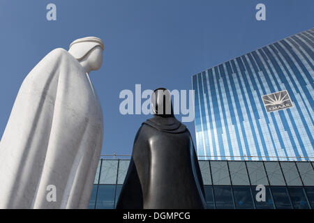 Sculpture of an Arab man and an Arab woman in front of the EMAAR building, Dubai, United Arab Emirates, Middle East, Asia