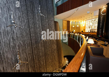 Cafe overlooking The Waterfall, an artificial indoor waterfall with life-size sculptures of divers, Dubai Mall Stock Photo