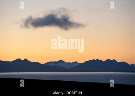 A single cloud hovers in the evening twilight over Isfjorden, Svalbard, Spitsbergen, Norway, Scandinavia, Europe Stock Photo