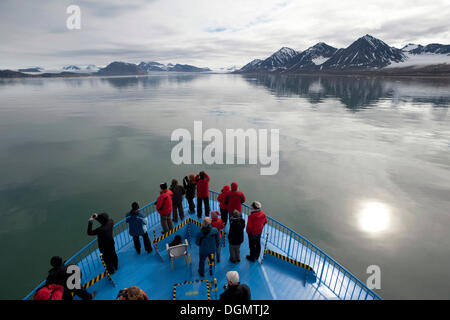 Passengers of the expedition cruise ship, MS Quest, observing the scenery of Kongsfjorden, Spitsbergen Island Stock Photo