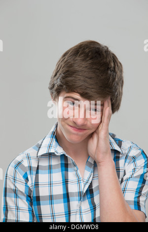 Portrait of teenage boy (14-15) making a face Stock Photo