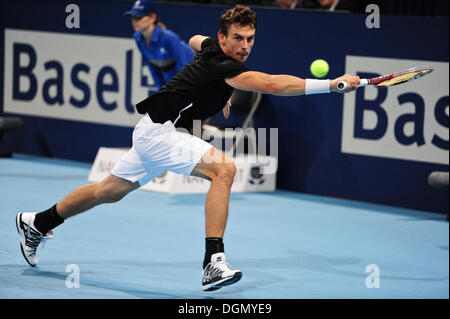 Basel, Switzerland. 23 Oct, 2013. Henri Laaksonen (SUI) swings for the ball during the 1st round of the Swiss Indoors at St. Jakobshalle on Wednesday. Photo: Miroslav Dakov/Alamy Live News Stock Photo