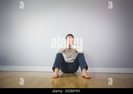 Casual sad man covering his face with hands Stock Photo