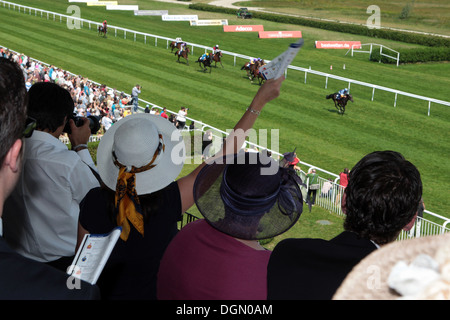 Iffezheim, Germany, woman with hat cheers at the races Stock Photo