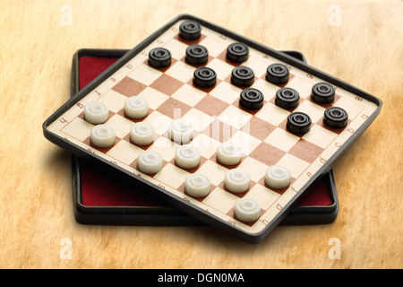 Travelling draughts on aged background Stock Photo