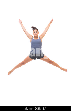 Pretty sporty brunette jumping in the air Stock Photo