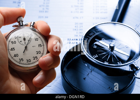 Hand holding stopwatch on budget numbers Stock Photo