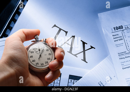 Operating budget, calendar, tax and stopwatch in hand Stock Photo