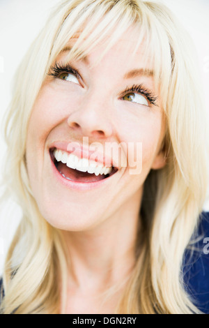 Portrait of enthusiastic blonde woman with toothy smile Stock Photo - Alamy