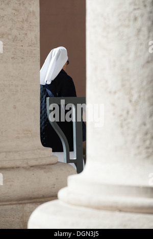 Nun walk in St Peter's colonnades Stock Photo