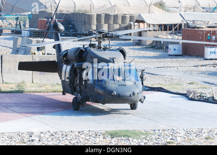 A 10th Combat Aviation Brigade UH-60L Black Hawk helicopter crewed by members of the Massachusetts National Guard, prepares to depart the forward arming and refueling point at Forward Operating Base Fenty, in order to conduct a personnel movement mission Stock Photo