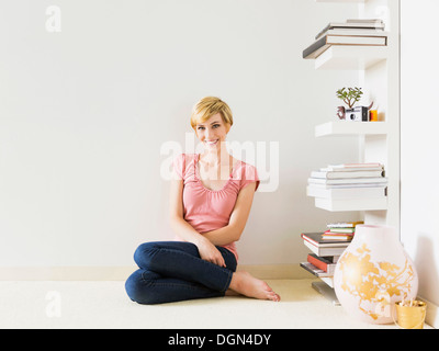 Smiling woman at home, studio shot Stock Photo