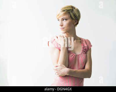 Young woman looking away, studio shot Stock Photo