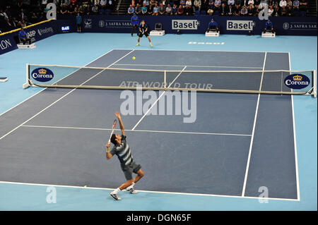 Basel, Switzerland. 23 Oct, 2013. Roger Federer (SUI) (down) serves during the 2nd round of the Swiss Indoors at St. Jakobshalle on Wednesday. Photo: Miroslav Dakov/Alamy Live News Stock Photo