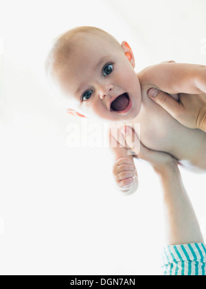 Baby boy (6-11 months) held by mother Stock Photo
