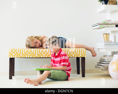 Kids (4-5, 6-7) using digital tablet indoors Stock Photo