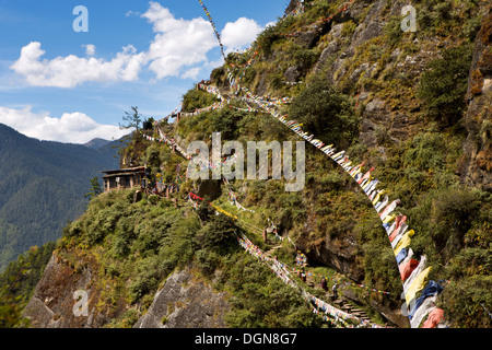 Bhutan, Paro valley, prayer flags above path to Taktsang Lhakang (Tiger's Nest) monastery Stock Photo