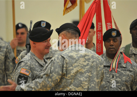 Col. Jody Miller accepts the 4-2 Stryker Brigade Combat Team, 7th Infantry Division colors from the 7th Inf. Div. commander, Maj. Gen. Stephen R. Lanza, signifying Miller's role as the incoming brigade commander during a Change of Command ceremony Oct. 16 Stock Photo