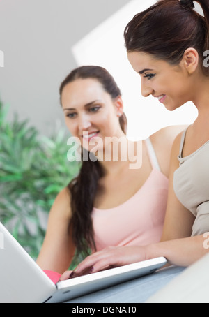 Two young women working with their notebook Stock Photo