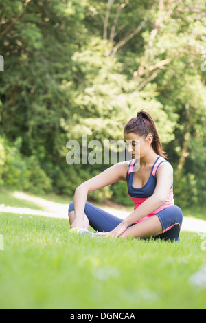 Woman young brunette bare ground sitting back view Stock Photo - Alamy