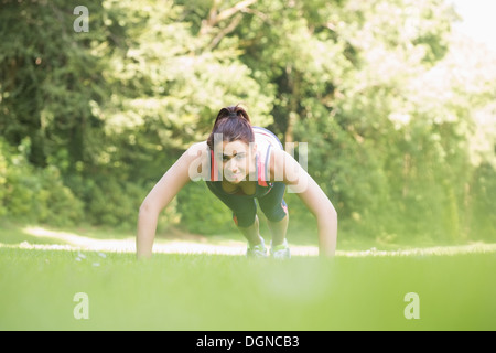 Fit young woman doing plank position Stock Photo