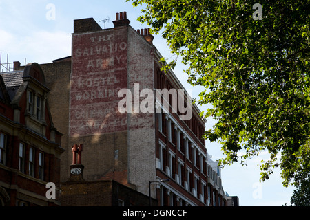 'The Salvation Army Hostel For Working Men Cheap Beds And Food' Old painted sign, Old Street, London, England, UK. Stock Photo