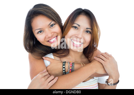 Two pretty sisters posing in front of the camera Stock Photo