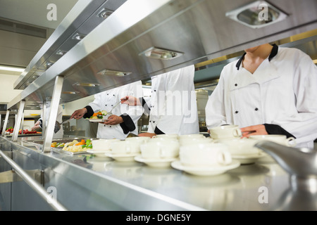 Four chefs working in a kitchen Stock Photo