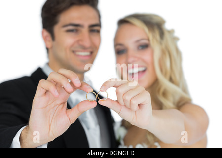 Cheerful married couple showing their wedding rings Stock Photo