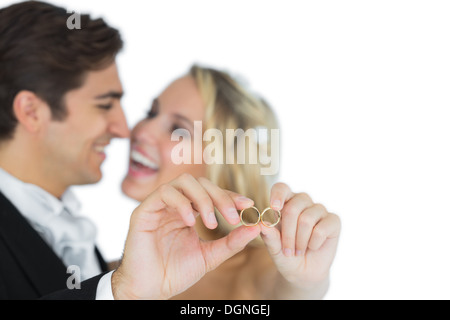 Happy attractive married couple showing their wedding rings Stock Photo